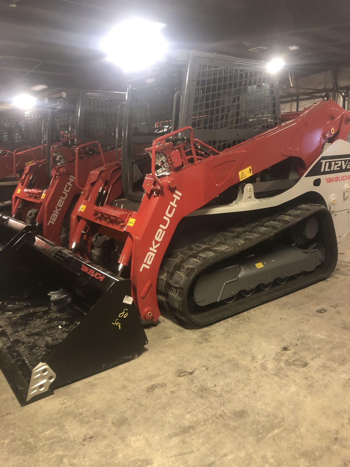 2019 Takeuchi TL12V2C ROPS/FOPS Cab, Heat/AC, Defroster, Rubber Tracks, Back-up Alarm, Front & Rear Working Lights, Auxiliary Hydraulics, Two-Speed Travel, Electronic Monitoring System, Hydraulic Universal Quick Hitch w/80" HD Smooth Dirt Bucket with Bolt-on Edge, 24.0 cu ft. Capacity
